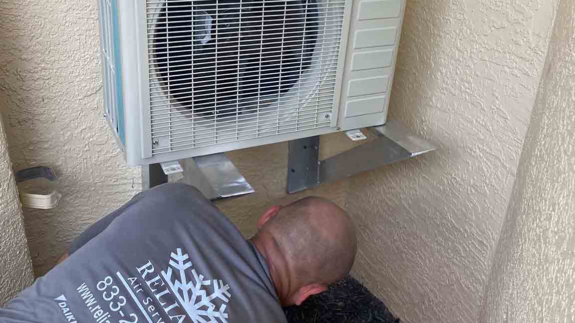 HVAC Technician Checking AC System for Damage