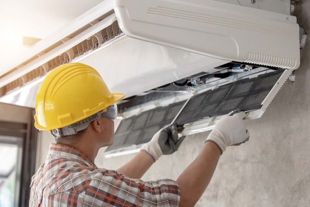 HVAC system being cleaned by a technician