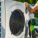 HVAC Worker Installing Energy Saving Heat Pump Sarasota, FL